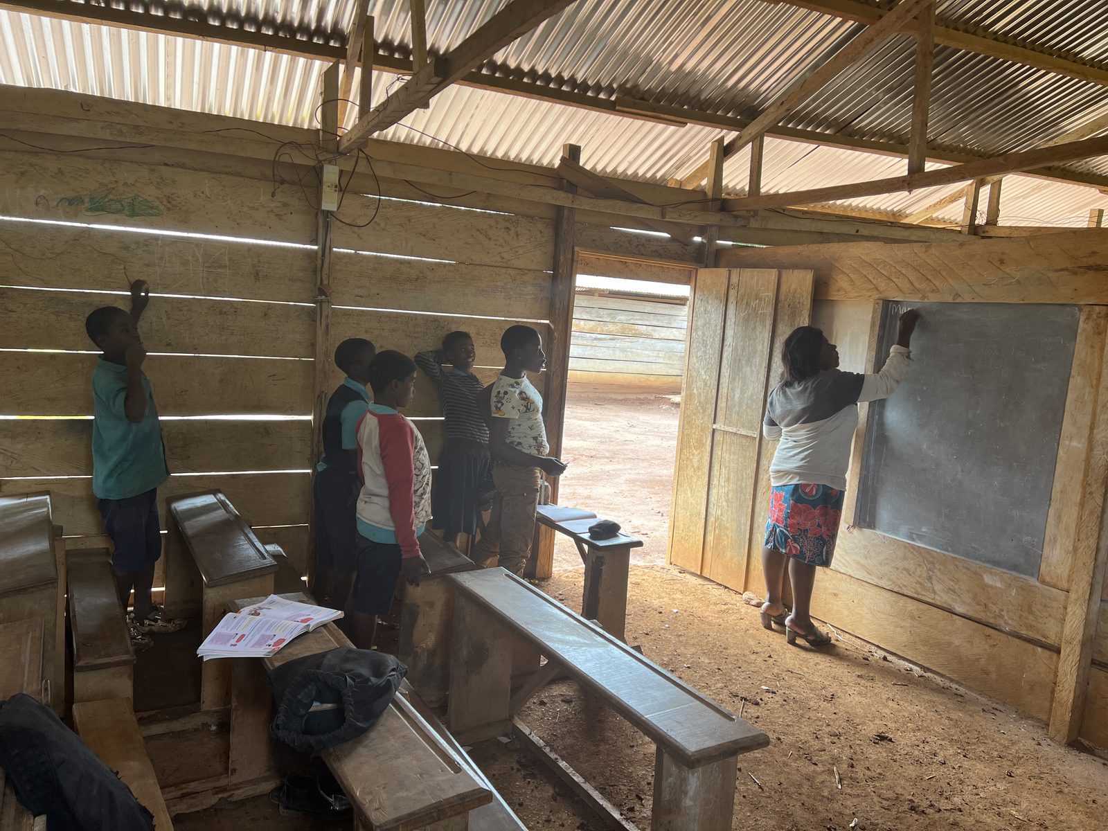 Students working at the chalkboard in a village school